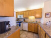 fully-equipped-kitchen-with-new-dishwasher-stove-sink-and-microwave-above